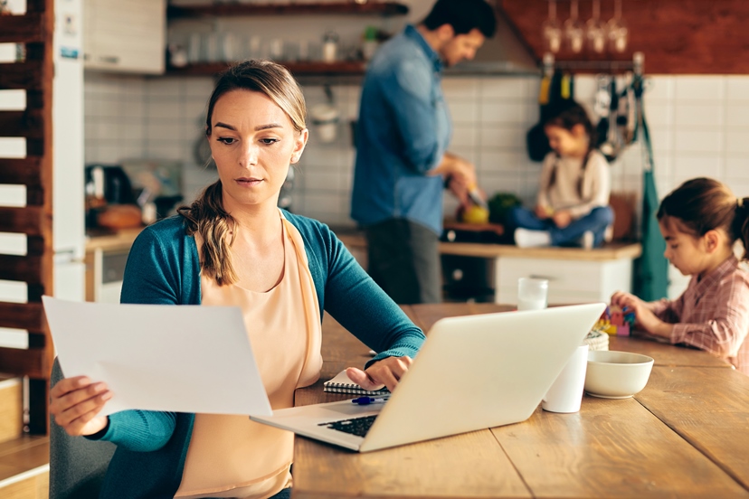 AdobeStock_420655063_Frau mit Dokumenten und Laptop